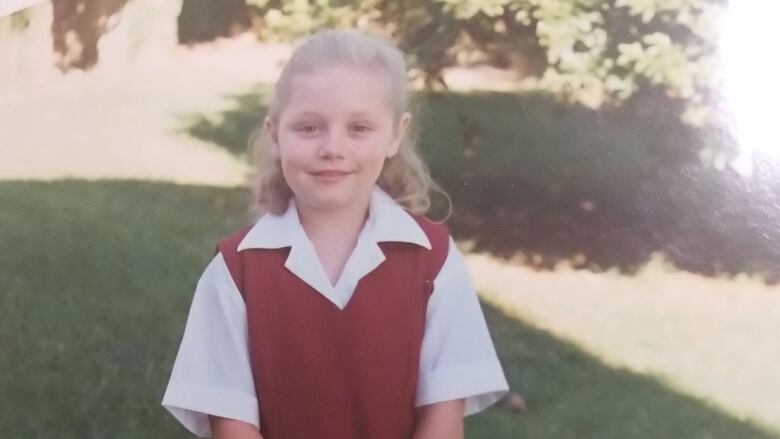 A girl in a school uniform.