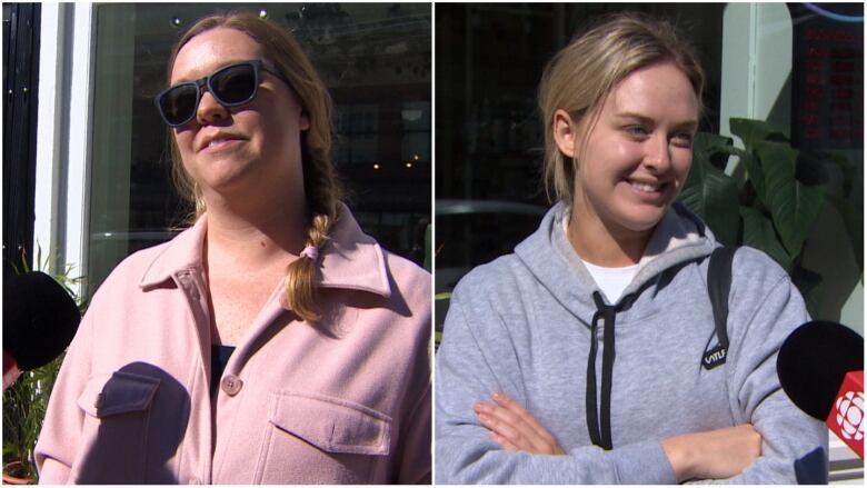 Two women stand in front of a microphone while being interviewed on the sidewalk in front of a restaurant.