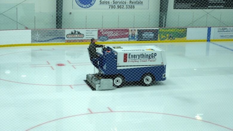 An ice resurfacer move son a hockey rink. 