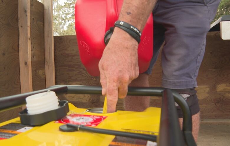 Small generator being filled with gas.