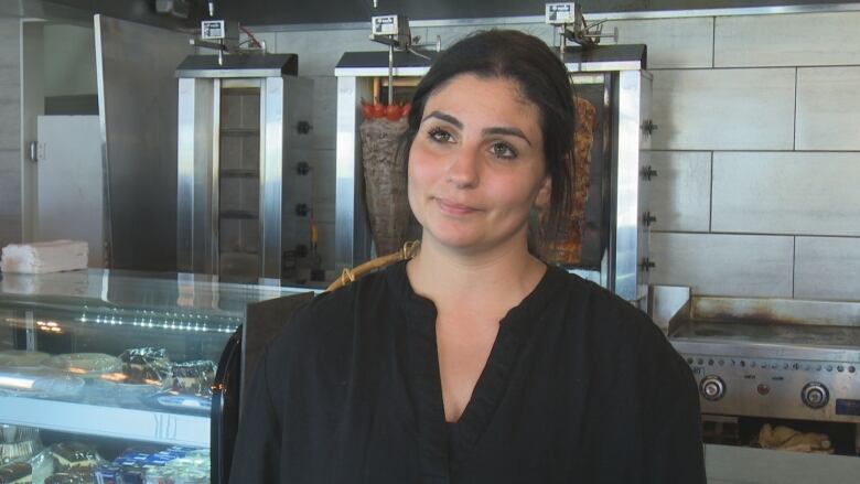 Photo of a woman inside a restaurant kitchen 