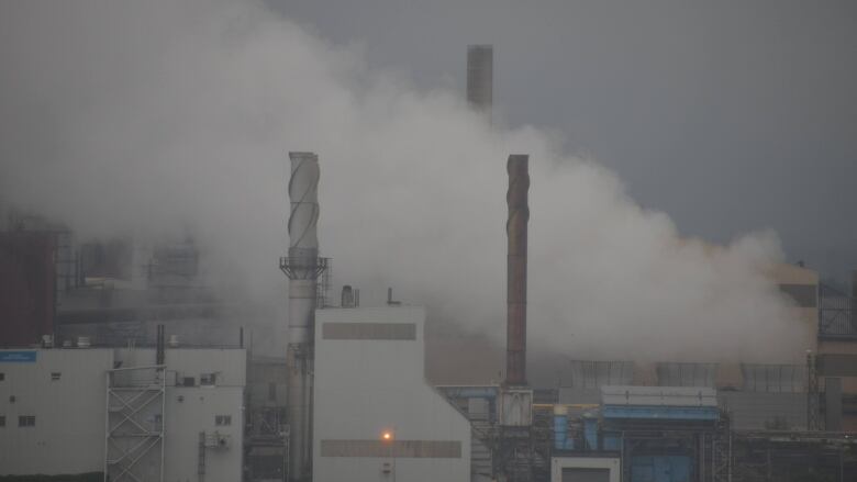 Three smokestacks at the Algoma steel plant in Sault Ste. Marie are engulfed in smoke