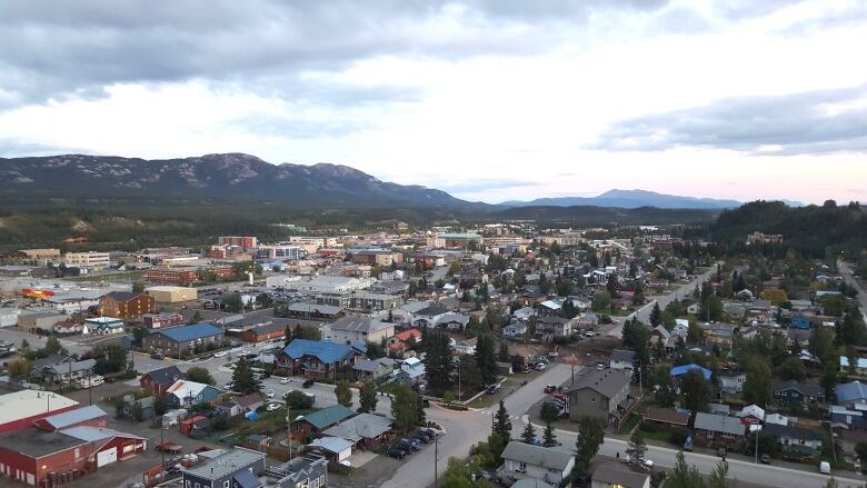 Overlooking a city with mountains in the background.