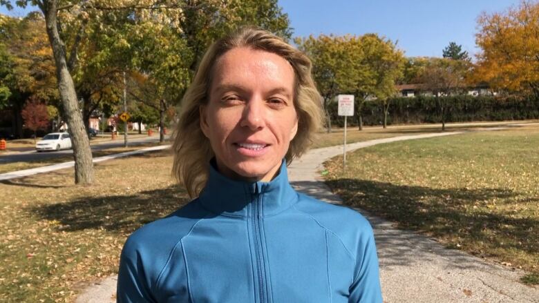 Woman wearing blue sports top.