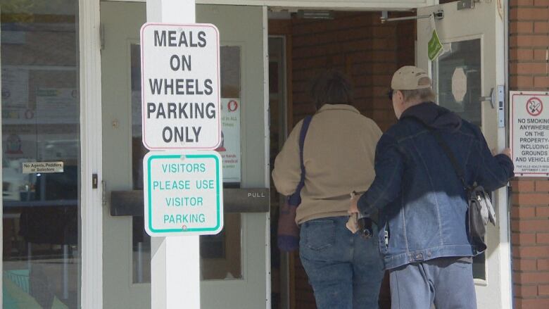 Two people walk into an SHA facility