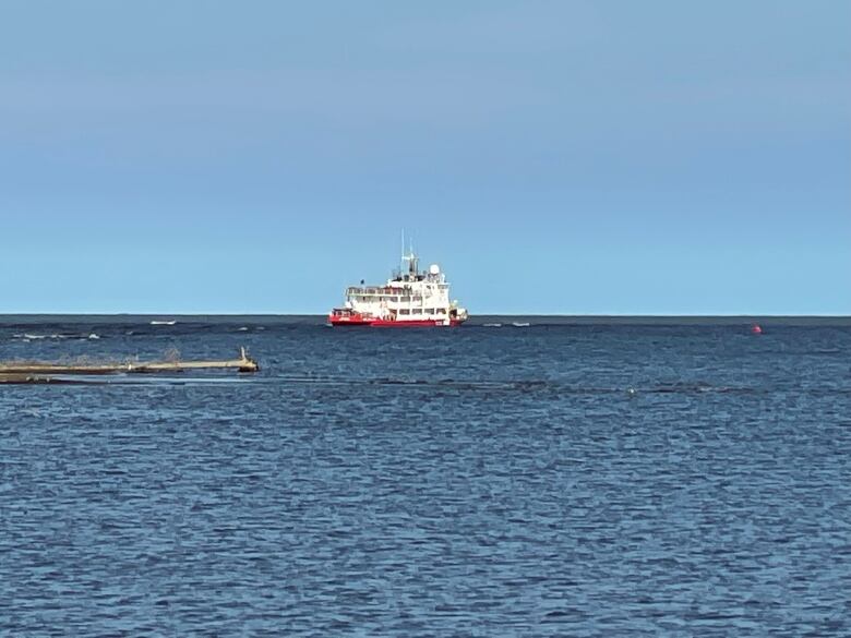 A Canadian Coast Guard vessel is seen on a lake, from a distance.