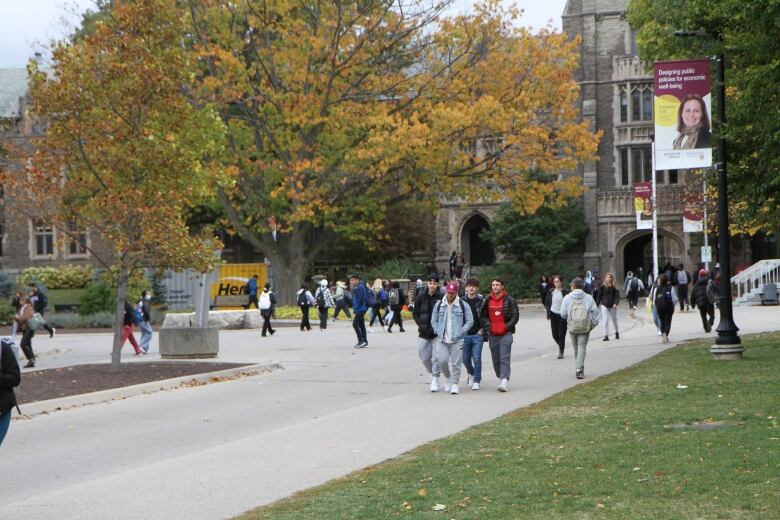 Many students are walking in between classes on campus.