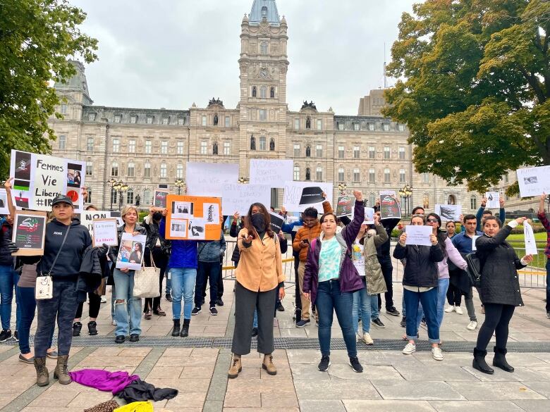 group of people stand together with signs. 