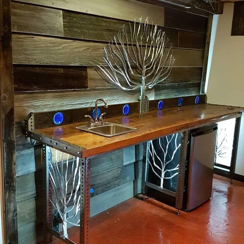 A photo shows a woodworked bar.