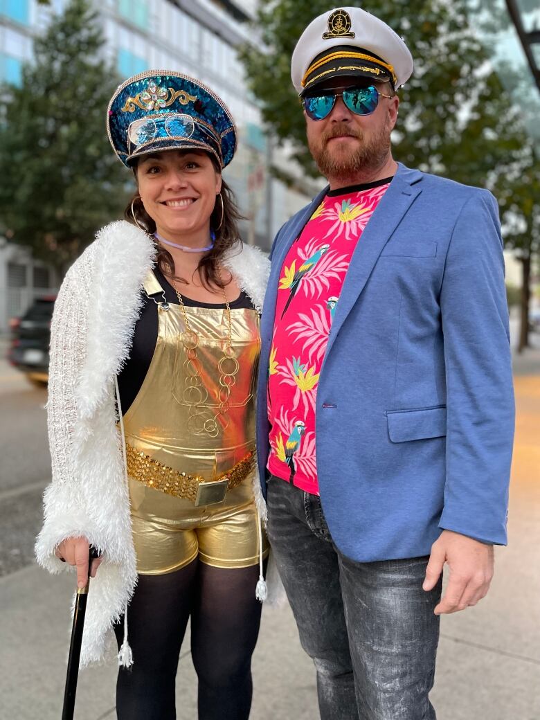 Two people dressed in sailors' outfits.