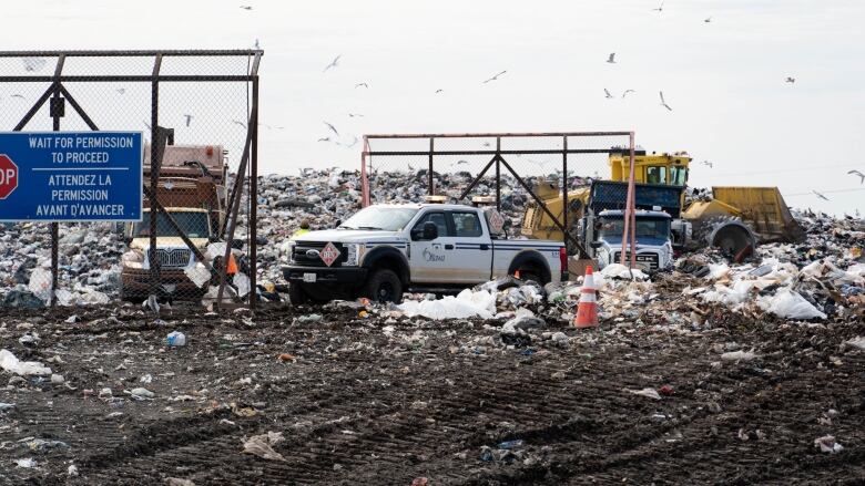 Vehicles move through a landfill.