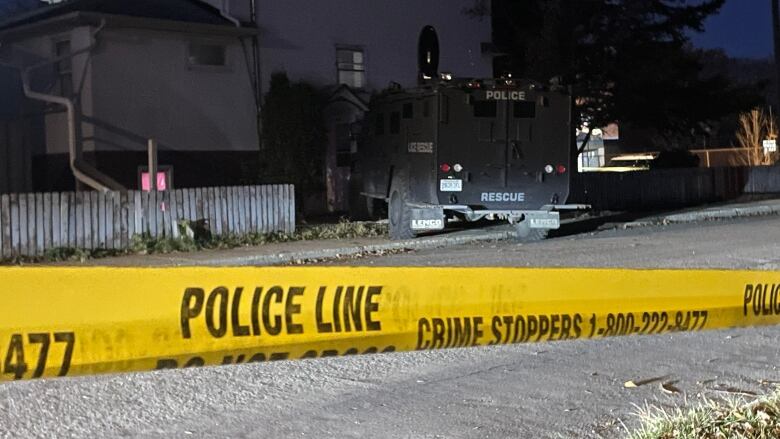 An armoured truck sits in front of a home.