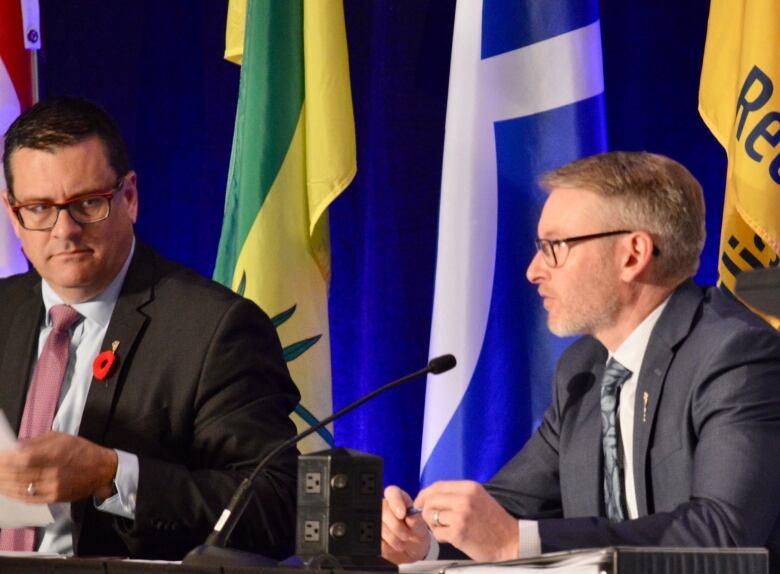 Paul Merriman, Saskatchewan's minister of health, sits with Everett Hindley, Saskatchewan's minister of mental health and addictions, seniors and rural and remote health, at the Saskatchewan Medical Association's 2022 assembly in Regina, Sask. 