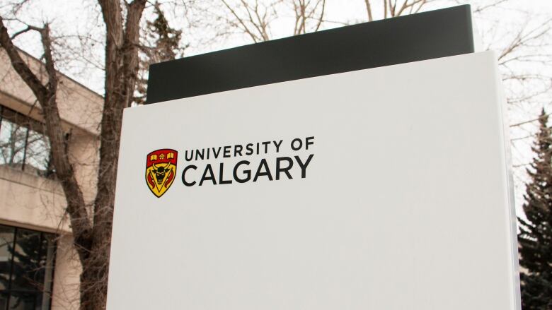 A sign that says University of  Calgary on it. It's also adorned with the school's red and white crest.