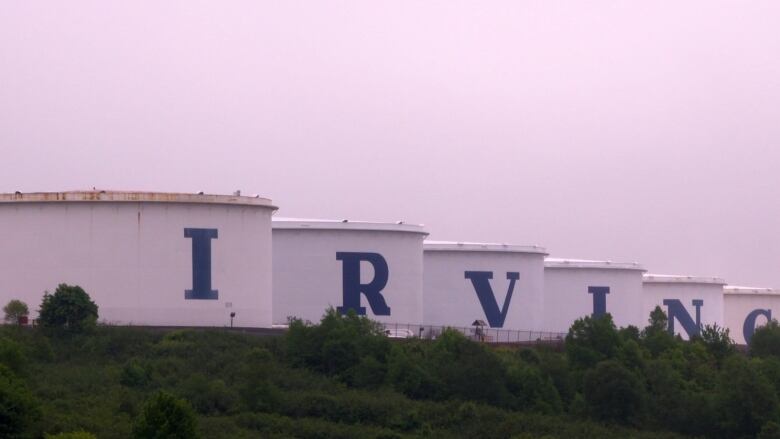 Large oil tanks spell out the letters I-R-V-I-N-G. 