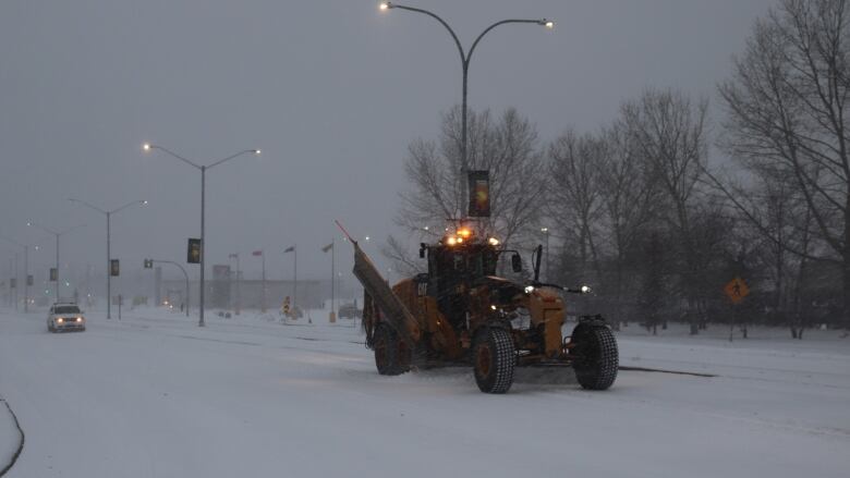 Snow plows clear snow in northern Manitoba.