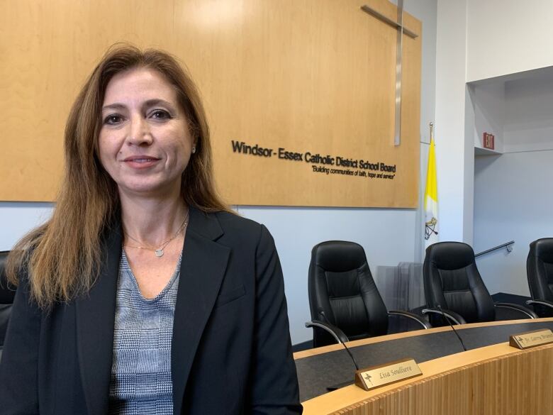 Woman stands in board room