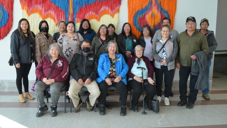 Seventeen people pose for a family photo at the inquest into the deaths of Don Mamakwa and Roland McKay.