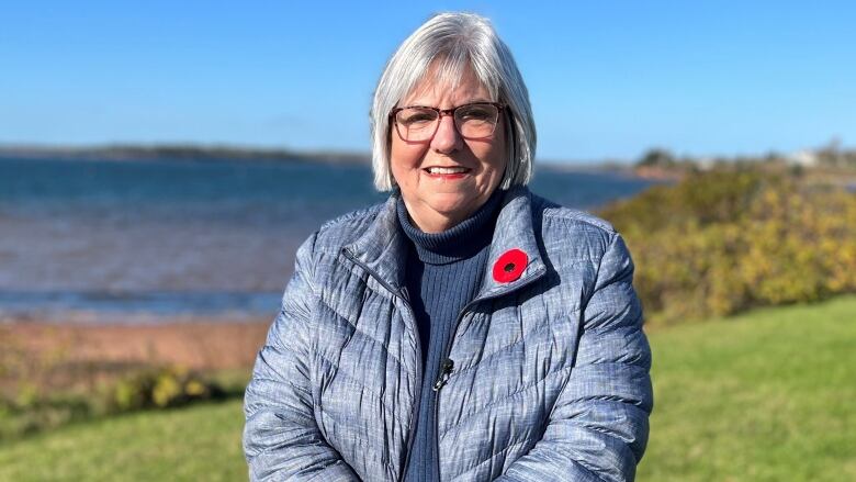 Debbie Johnston standing by the shore.