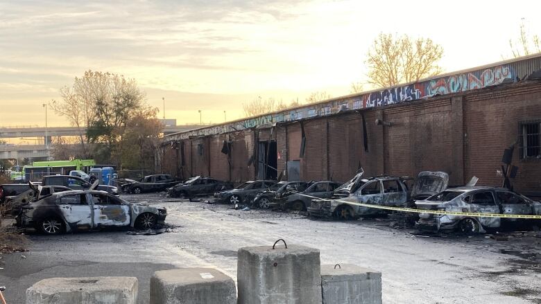 Burnt Cars are in a parking lot.