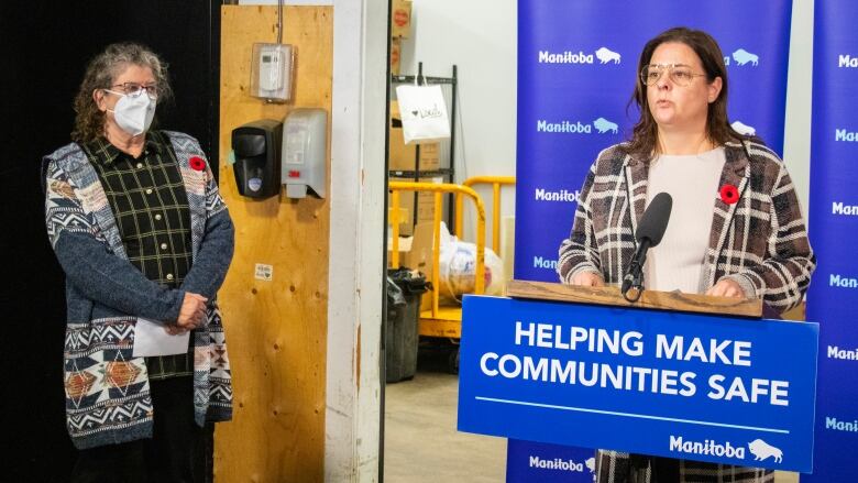 A woman stands a podium speaking.