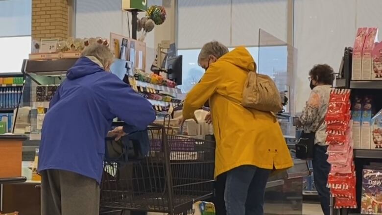 Customers line up to pay for items at a Sobeys in Halifax on Monday.