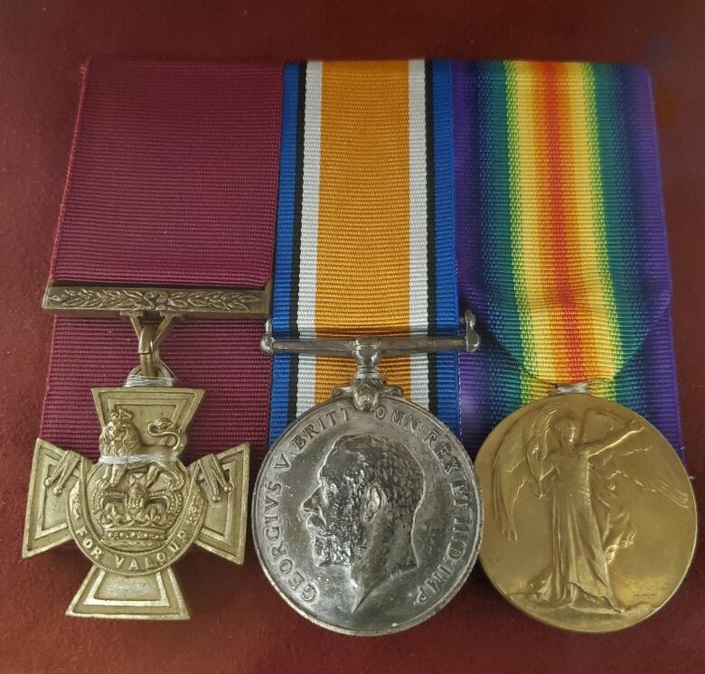 Three military medals are displayed.