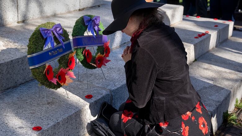 A woman pays her respects at Remembrance Day ceremonies at the Grand Parade in Halifax.