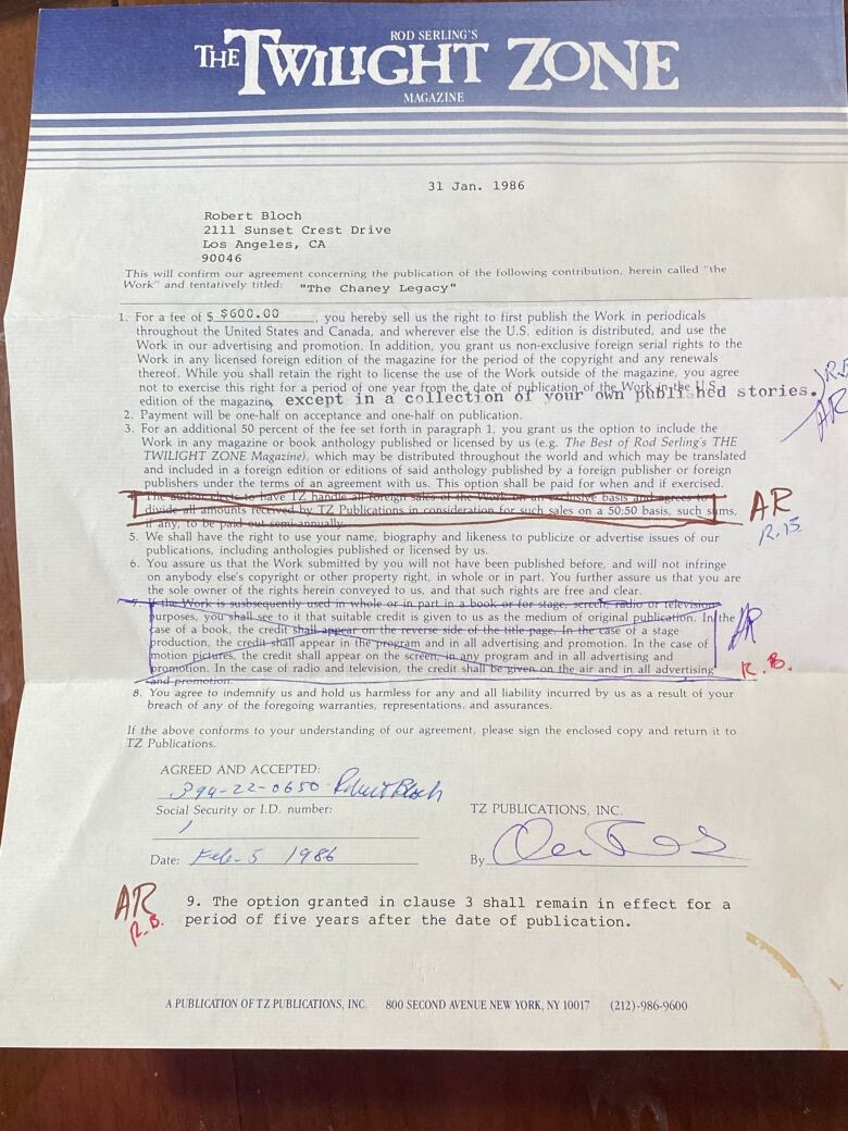 A contract with blue pen markings on it is pictured.