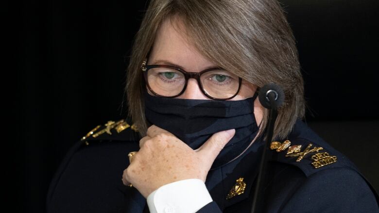 RCMP Commissioner Brenda Lucki reads a document as she appears as a witness at the Public Order Emergency Commission, Tuesday, November 15, 2022 in Ottawa.