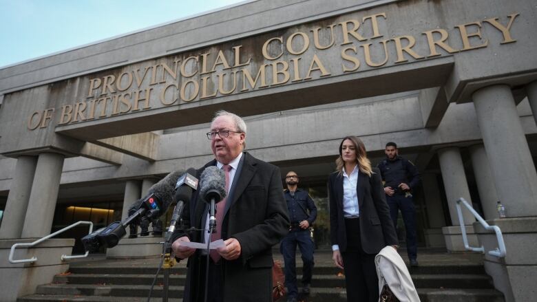 Former Surrey mayor Doug McCallum reads a brief statement outside provincial court after being found not guilty of public mischief, in Surrey, B.C., on Monday, November 21, 2022.