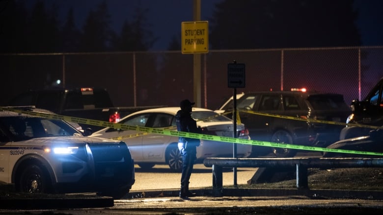 Surrey RCMP officers are pictured collecting evidence