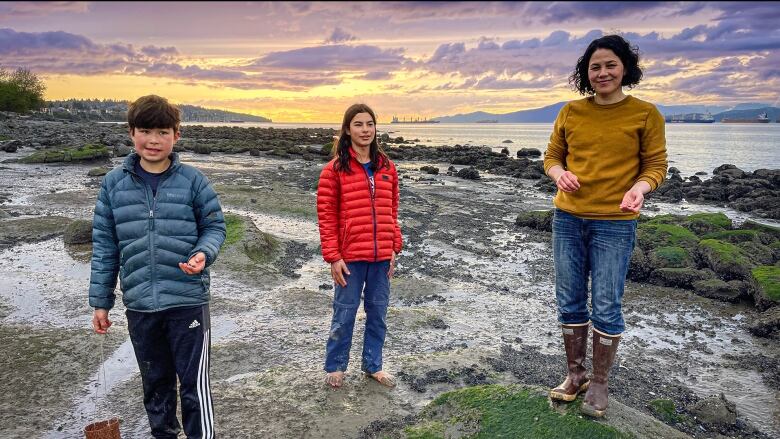 Severn Cullis-Suzuki stands on the Vancouver shoreline with her two children. 