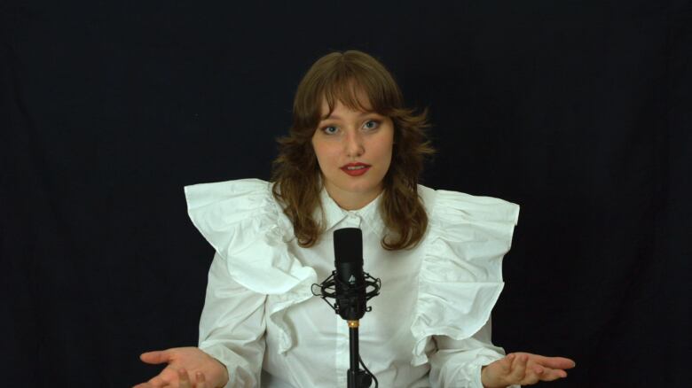 A woman speaks into a microphone.