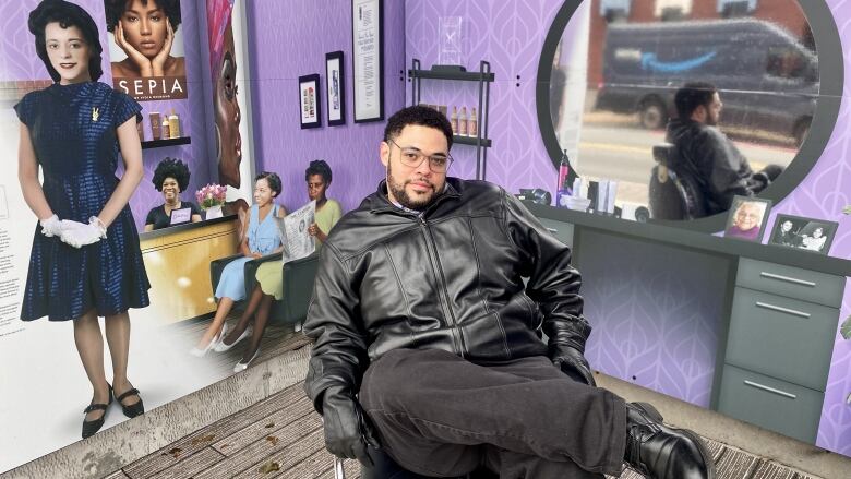 A Black man sitting in a barber's chair