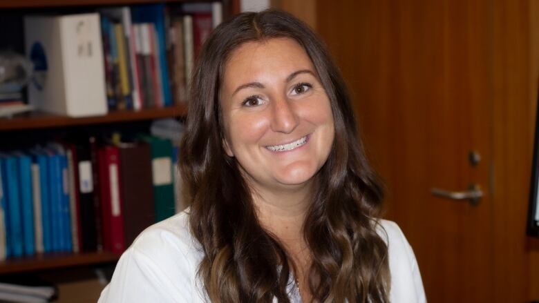 Nicole Novroski with bookcase in background.