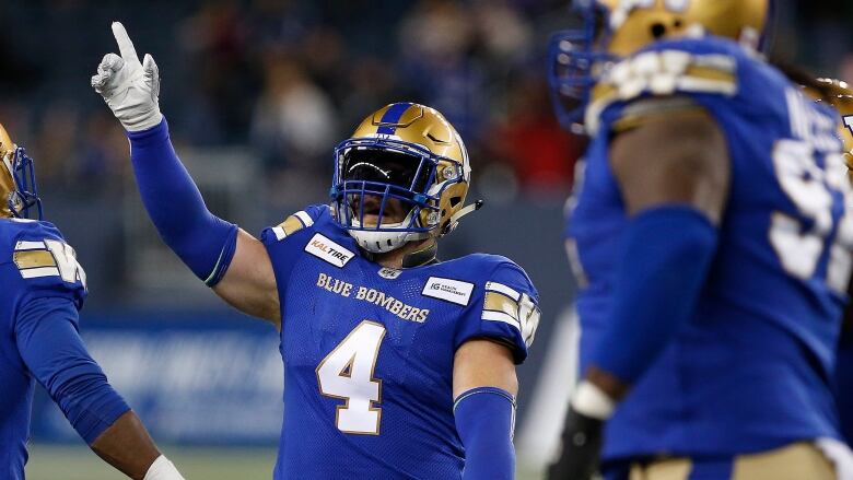 A football player in a blue jersey. 