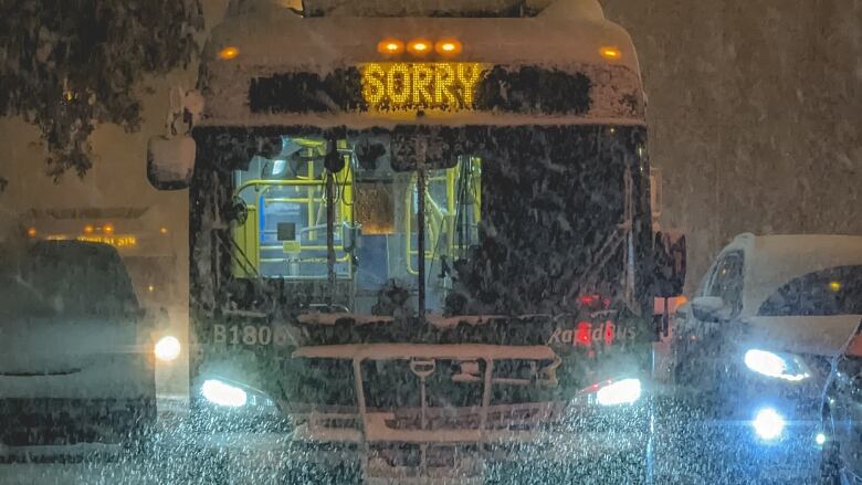 A bus in snowy weather with a chyron reading 'Sorry.'