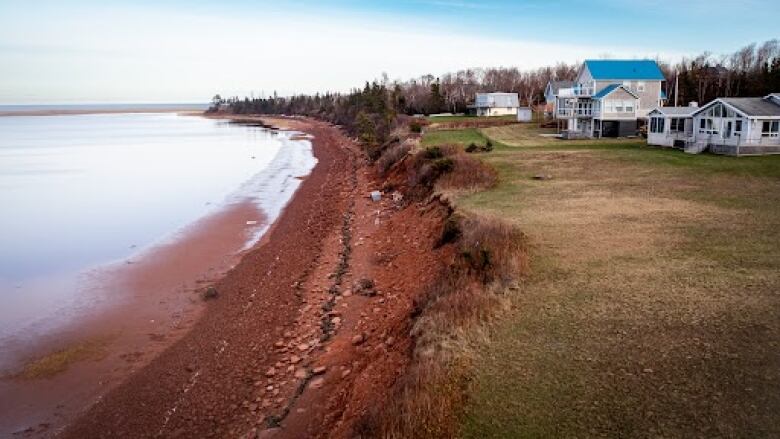 Aerial view of damage from Fiona in front of a row of houses