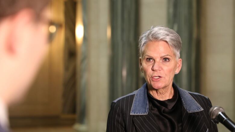 Saskatchewan's minister of correction policing and public safety, Christine Tell, speaks with media at the provincial legislature in Regina on Dec. 1, 2022. 