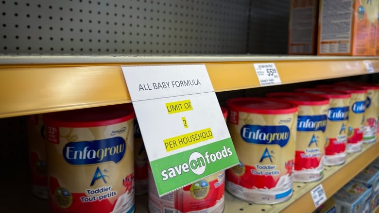 Baby formula is pictured on a shelf with a limit per customer at a grocery store.