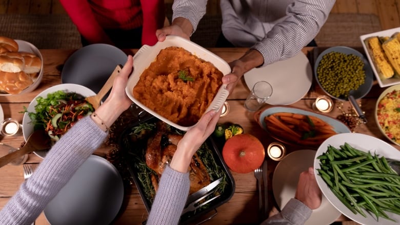 Thanksgiving dishes are seen on a table. 