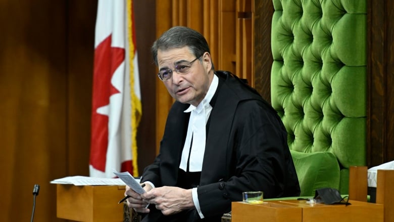 The Speaker of the House of Commons sits in his chair.