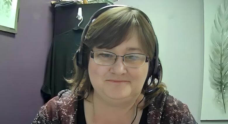 Woman with a headphone takes part in a Zoom call