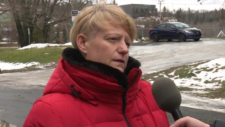 A woman speaking into a microphone.