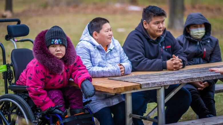 Tijay Kunilisie, at left, is accompanied for her medical appointments to Ottawa by her mother, father and brother. 