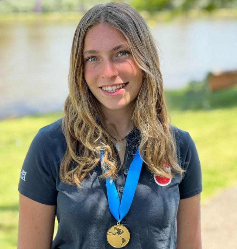 Hannah Stopnicki smiling and wearing her gold medal.