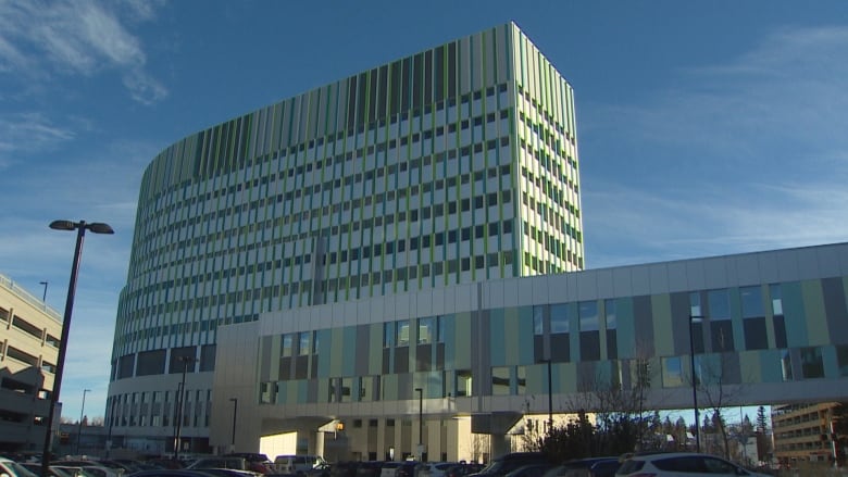 A building is pictured with a clear blue sky in the background.