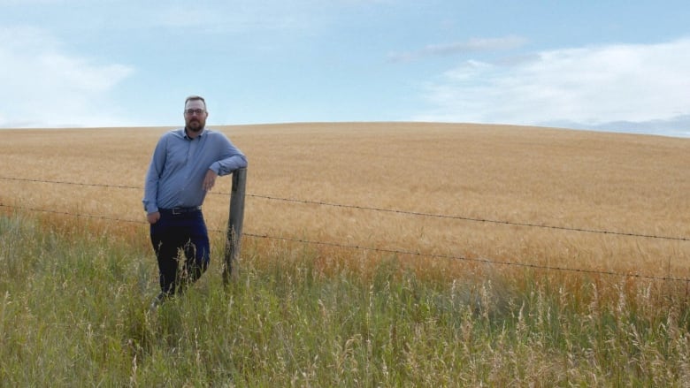 A man stands in a field.