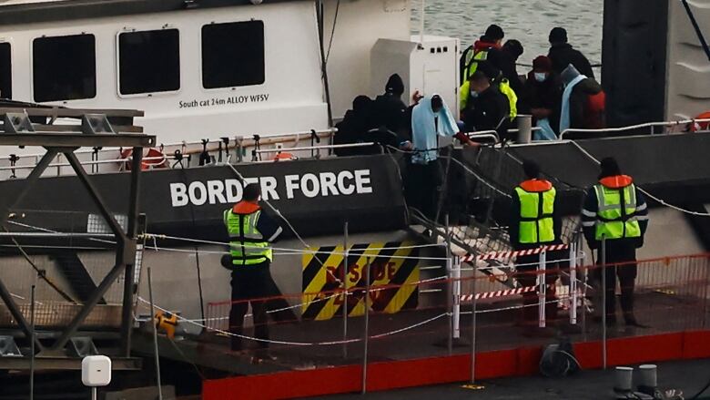 Border officials pick up migrants in Dover.